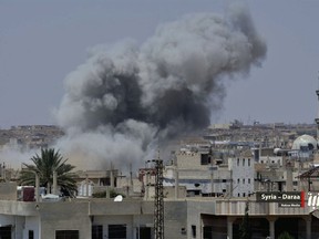 This photo provided by Nabaa Media, a Syrian opposition media outlet, shows smoke rising over buildings that were hit by Syrian government forces bombardment, in Daraa, southern Syria, Tuesday, June 26, 2018. Fighting escalated in southern Syria Tuesday with government forces pushing deeper in the southern Daraa province under the cover of airstrikes as residents said they are living in extreme fear and many have fled their homes with the U.N. estimating that 45,000 people have been displaced over the past week. (Nabaa Media, via AP)