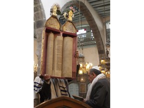 FILE - This Sunday, April 20, 2008, file photo, Syrian Jews celebrate Passover at the al-Firenj Synagogue in downtown Damascus, Syria. Artifacts removed from one of the oldest synagogues in the world in the Syrian capital have gone missing after neighborhood officials said they gave them to commanders of a rebel group who never gave them back. Syria has blamed Israel and Turkey for looting artifacts from the synagogue.