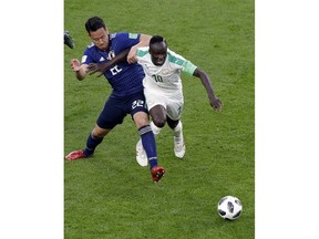 Japan's Maya Yoshida, left, and Senegal's Sadio Mane battle for the ball during the group H match between Japan and Senegal at the 2018 soccer World Cup at the Yekaterinburg Arena in Yekaterinburg , Russia, Sunday, June 24, 2018.