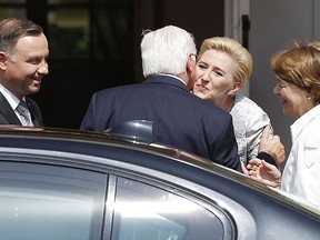 Polish President Andrzej Duda, left, and the first lady, Agata Kornhauser-Duda, 2nd right, welcome German President Frank-Walter Steinmeier, 2nd left, and his wife Elke Buedenbender, right, for a visit in Warsaw, Poland, Tuesday, June 5, 2018.