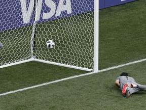 Panama goalkeeper Jaime Penedo lies on the ground after failing to stop a goal from England's Jesse Lingard during the group G match between England and Panama at the 2018 soccer World Cup at the Nizhny Novgorod Stadium in Nizhny Novgorod, Russia, Sunday, June 24, 2018.