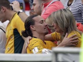 A crying woman embraces Australia's Jackson Irvine at the end of the group C match between Australia and Peru, at the 2018 soccer World Cup in the Fisht Stadium in Sochi, Russia, Tuesday, June 26, 2018.