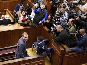 Convicted killer Henri van Breda, front left, appears in the High Court in Cape Town, South Africa, Tuesday June 5, 2018, to await his sentencing after being found guilty for the murder of his parents and brother and the attempted murder of his sister. The sentencing hearing was postponed until Thursday.