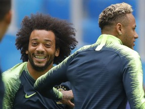 Brazil's Neymar, right, and Marcelo exercise during Brazil's official training on the eve of the group E match between Brazil and Costa Rica at the 2018 soccer World Cup in the St. Petersburg stadium in St. Petersburg, Russia, Thursday, June 21, 2018.
