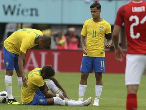 Brazil's Neymar holding his ankle after a challenge with Austria's Julian Baumgartlinger during a friendly soccer match between Austria and Brazil at the Ernst Happel Stadium in Vienna, Austria, Sunday, June 10, 2018.