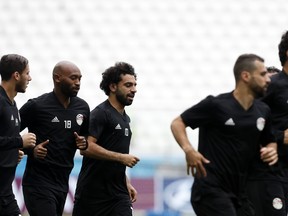 Players run during Egypt's official training on the eve of the group A match between Saudi Arabia and Egypt at the 2018 soccer World Cup in the Volgograd Arena, in Volgograd, Russia, Sunday, June 24, 2018.
