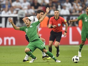Saudi Arabia's Taisir Al-Jassim, front left, duels for the ball with Germany's Mats Hummels during a friendly soccer match between Germany and Saudi Arabia at BayArena in Leverkusen, Germany, Friday, June 8, 2018.