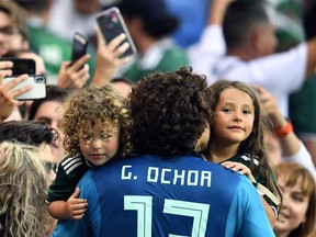 Mexico goalkeeper Guillermo Ochoa celebrates with family members at the end of the group F match between Mexico and South Korea at the 2018 soccer World Cup in the Rostov Arena in Rostov-on-Don, Russia, Saturday, June 23, 2018.