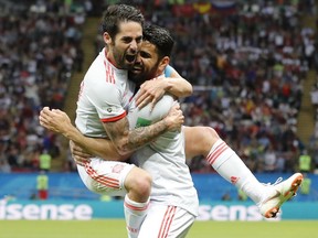 Spain's Diego Costa, right, celebrate after scoring his side's opening goal with Spain's Isco during the group B match between Iran and Spain at the 2018 soccer World Cup in the Kazan Arena in Kazan, Russia, Wednesday, June 20, 2018.