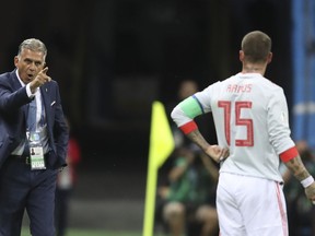 Iran head coach Carlos Queiroz, left, gestures to Spain's Sergio Ramos during the group B match between Iran and Spain at the 2018 soccer World Cup in the Kazan Arena in Kazan, Russia, Wednesday, June 20, 2018.