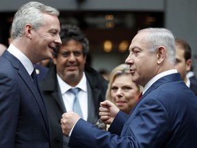 French Finance Minister Bruno Le Maire accompanies Israel's Prime Minister Benjamin Netanyahu after their meeting at Bercy Economy Ministry, in Paris, Wednesday, June 6, 2018. Netanyahu met French Finance Minister Bruno Le Maire, who is pushing to maintain European trade with Iran allowed under the 2015 deal curbing Iranian nuclear activities.