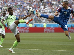 Nigeria's John Obi Mikel, left, and Iceland's Gylfi Sigurdsson compete for the ball during the group D match between Nigeria and Iceland at the 2018 soccer World Cup in the Volgograd Arena in Volgograd, Russia, Friday, June 22, 2018.