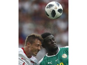 Poland's Thiago Cionek, left, and Senegal's Alfred Ndiaye, right, go for a header during the group H match between Poland and Senegal at the 2018 soccer World Cup in the Spartak Stadium in Moscow, Russia, Tuesday, June 19, 2018.