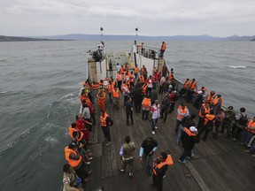An Indonesia search and rescue team searches for a ferry which sank Monday in lake Toba, North Sumatra, Indonesia, Tuesday, June 19, 2018. Rescuers searching for dozens of people missing after a ferry sank on Indonesia's Lake Toba have found bags, jackets, an ID card and other items in the waters but no new survivors, casting a tragic pall over holidays marking the end of the Muslim holy month.