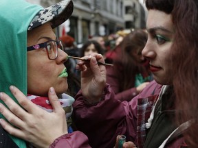 Pro-choice demonstrators paint their faces during a concentration to support an abortion legalization law, near Argentina's congress in Buenos Aires, Wednesday, June 13, 2018. Argentina's legislature has begun debating a measure that would allow elective abortions in the first 14 weeks of gestation. It's a debate that has sharply divided the homeland of Pope Francis.