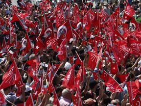 Supporters of Muharrem Ince, the presidential candidate of Turkey's main opposition Republican People's Party, wave Turkish and party flags as they wait for his arrival at a rally, in Istanbul, Saturday, June 16, 2018. Turkey's President Recep Tayyip Erdogan is facing a tough challenge to his 15 years in power as a more united and galvanized opposition tries to thwart his attempt to remain in office for five more years _ and with vastly increased.