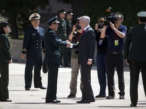 U.S. Defense Secretary Jim Mattis, center right, is greeted by China's Defense Minister Wei Fenghe, third from left, as he arrives for a welcome ceremony at the Bayi Building in Beijing, Wednesday, June 27, 2018.