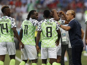 Nigeria head coach Gernot Rohr, right, talks with his players as they celebrate their first goal during the group D match between Nigeria and Iceland at the 2018 soccer World Cup in the Volgograd Arena in Volgograd, Russia, Friday, June 22, 2018.
