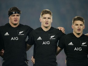 FILE - In this Saturday July 8, 2017 file photo, the Barrett brothers from left, Scott, Jordie and Beauden embrace during the national anthem ahead of the start of the third and final rugby test between the British and Irish Lions against the All Blacks at Eden Park in Auckland, New Zealand.The Barrett's will become the first trio of brothers to start a test for the All Blacks when they line up for the first test against France to be played at Auckland's Eden Park on Saturday June 9, 2018.