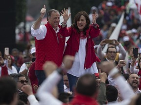Presidential candidate Jose Antonio Meade, of the Institutional Revolutionary Party, PRI, left, and his wife Juana Cuevas arrive to a campaign rally in Toluca, Mexico, Sunday, June 24, 2018. Mexico's four presidential candidates are holding their last weekend of campaigning before the country's July 1 elections.