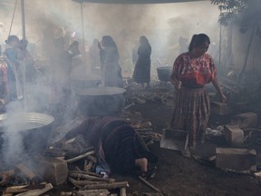 Women cook for neighbors and relatives during the second day of a wake for 19-year-old Guatemalan immigrant Claudia Gomez Gonzalez in San Juan Ostuncalco, Guatemala, Friday, June 1, 2018. The young woman, who was fatally shot by a U.S. Border Patrol agent in Texas, had graduated as a forensic accountant but was unable to attend college or find a job, so she had left Guatemala for the U.S., according to her aunt.