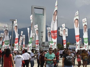 Supporters of presidential candidate Jose Antonio Meade, of the Institutional Revolutionary Party (PRI), arrive for his closing campaign rally in Monterrey, Mexico, Wednesday, June 27, 2018. Mexico's four presidential candidates are closing their campaigns before the country's July 1 elections.