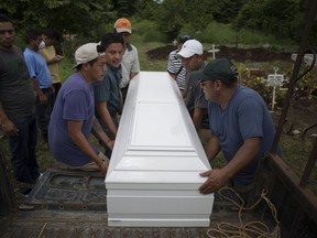 Relatives carry a coffin that contain the remains of Sandra Orizabal Diaz during her burial at the cemetery in Escuintla, Guatemala, Thursday, June 7, 2018. Orizabal's body was interred next to the grave of her husband. All told, 18 members of the family died or disappeared in the disaster.