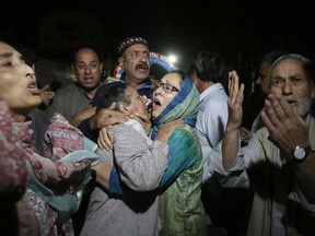 Relatives and friends of journalist Shujaat Bukhari cry inside a police control room in Srinagar, India, Thursday, June 14, 2018. Bukhari and his police bodyguard were shot and killed Thursday by assailants in Indian-controlled Kashmir, police and journalist's colleagues said. Bukhari, who is a group editor for three daily newspapers and a weekly, including the English-language daily Rising Kashmir, was targeted as he got into his vehicle.