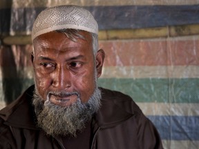 In this Jan. 16, 2018, photo, Rohingya refugee Rahamat Ullah, 53, a mullah from Koe Fan Kauk village, sits in his makeshift shelter in Kutupalong refugee camp near Cox's Bazar, Bangladesh.  "We are being targeted because people listen to us," he said. Associated Press interviews with nearly a dozen Rohingya teachers, elders and religious leaders reveal that educated Rohingya were already subject to systematic and widespread harassment, arrests, torture and, in some cases, killings.