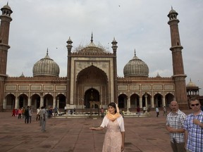 U.S. Ambassador to the United Nations Nikki Haley, center, poses in front of Jama Masjid or mosque in New Delhi, India, Thursday, June 28, 2018. Haley offered inter-faith prayers in New Delhi on Thursday, visiting a Sikh shrine, a Hindu temple, a Jain temple, a Church and a Muslim mosque in the old, walled area of the Indian capital. The United States on Wednesday announced postponement of a high-level dialogue with India scheduled for next week in Washington, D.C., without assigning any reasons even as its ambassador to the United Nations met with top Indian leaders in New Delhi to step up ties in various fields.