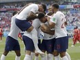 England players run to teammate John Stones after he scored his team's first goal during the group G match between England and Panama at the 2018 soccer World Cup at the Nizhny Novgorod Stadium in Nizhny Novgorod, Russia, Sunday, June 24, 2018.