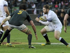 England's Elliot Daly, right, faces South Africa's Franco Mostert, left, during the third rugby test match between South Africa and England at Newlands in Cape Town, South Africa, Saturday, June 23, 2018.
