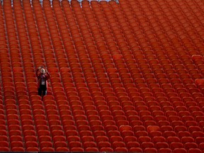 A volunteer takes a picture from the temporary stands in the Yekaterinburg Arena in Yekaterinburg, Russia, Thursday, June 21, 2018.The World Cup stadium in Yekaterinburg has two stands that are built outside the main structure. They sit atop towers of uncovered scaffolding. The stands are temporary and will be dismantled after the stadium's four World Cup games in the Ural Mountains city.