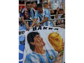 Argentina's fans hold a banner with a image of former soccer star Diego Maradona as they get ready to cheer on their side before the start of the group D match between Argentina and Iceland at the 2018 soccer World Cup in the Spartak Stadium in Moscow, Russia, Saturday, June 16, 2018.