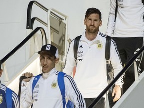 Lionel Messi, center right, and Angel Di Maria, center left, step out of the plane as Argentina national soccer team arrive at Zhukovsky international airport outside Moscow, Russia, Saturday, June 9, 2018 to compete in the 2018 World Cup in Russia. The 21st World Cup begins on Thursday, June 14, 2018, when host Russia takes on Saudi Arabia.