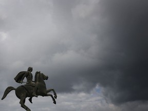 FILE- In this Wednesday, Oct, 8, 2014 file photo, a modern bronze statue of Alexander the Great stands under the cloudy sky of the northern port city of Thessaloniki, Greece.  Officials in Greece and Macedonia say Tuesday, June 12, 2018, they are close to reaching a landmark deal on a long-standing name dispute, to protect Greece's region of Macedonia, birthplace of ancient warrior king Alexander the Great, but the Greek coalition partner has vowed to vote against the proposed agreement.