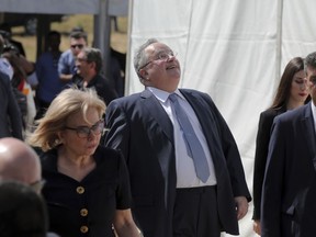 Greek Foreign Minister Nikos Kotzias, third right, arrives at the village Psarades, Prespes, Greece, before the signing of an agreement on Macedonia's new name, on Sunday, June 17, 2018. The preliminary deal launches a long process that will last several months. If successful, it will end a decades-long dispute between neighbors Greece and Macedonia _ which will be renamed North Macedonia.
