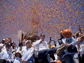 Presidential candidate Ricardo Anaya, of the left-right coalition Forward for Mexico, kicks a soccer ball to supporters under falling confetti during his campaign rally in Mexico City, Sunday, June 24, 2018. Mexico's four presidential candidates are holding their last weekend of campaigning before the country's July 1 elections.