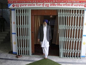 In this Thursday, June 7, 2018 photo, Avtar Singh Khalsa, a longtime leader of the Sikh community, who will represent Afghanistan's tiny Sikh and Hindu minority in the next parliament, leaves a gurdwara, a place of worship for Sikhs, after praying, in Kabul, Afghanistan. Few Afghans are as invested in the government's quest for peace and stability as the dwindling Sikh and Hindu minorities, which have been decimated by decades of conflict.