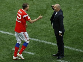 Russia head coach Stanislav Cherchesov salutes Artyom Dzyuba after he scored his side's third goal against Saudi Arabia in the group A match which opened the 2018 soccer World Cup at the Luzhniki stadium in Moscow, Russia, Thursday, June 14, 2018.