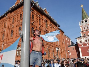 A fan waves an flag of Argentina on the eve of the Group D 2018 World Cup soccer match between Argentina and Iceland at the entrance of the Red Square in Moscow, Russia, Friday, June 15, 2018.