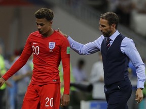 England head coach Gareth Southgate escorts Dele Alli after replacing him with Ruben Loftus-Cheek during the group G match against Tunisia at the 2018 soccer World Cup in the Volgograd Arena in Volgograd, Russia, Monday, June 18, 2018.