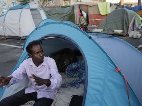 An asylum seeker from the Horn of Africa who did not want to be identified by his name sits in a tented camp set up by the Baobad aid group, on the outskirts of Rome, Tuesday, June 19, 2018. After dramatically blocking humanitarian group's ships from bringing yet even more migrants rescued at sea to Italian ports, Italian Interior Minister Matteo Salvini has proclaimed his next urgent mission: ridding his country of huge numbers of migrants who undertook dangerous treks through African deserts and risky voyages on smugglers' unseaworthy boats across the Mediterranean to reach their dream: a better life in Europe.