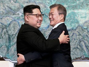 FILE - In this April 27, 2018 file photo, North Korean leader Kim Jong Un, left, and South Korean President Moon Jae-in embrace each other after signing on a joint statement at the border village of Panmunjom in the Demilitarized Zone, South Korea. North Korea's three East Asian neighbors - Japan, China and South Korea - have a shared goal of denuclearizing the North, but what may come out of Tuesday, June 12's summit in Singapore between U.S. President Donald Trump and North Korea's Kim Jong Un has different and possibly conflicting implications for their security, economic and geopolitical interests.(Korea Summit Press Pool via AP, File)
