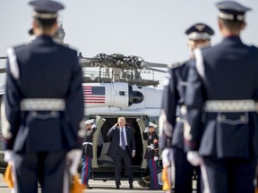 FILE - In this Nov. 8, 2017 file photo, President Donald Trump, center, steps out of Marine One to board Air Force One at Osan Air Base in Pyeongtaek, South Korea. Long a dream of Koreans on both sides of the world's most heavily armed border, a peace treaty that finally ends the 68-year-old (and still counting) Korean War is now being hinted at by President Donald Trump ahead of his summit Tuesday, June 12, 2018, with North Korean leader Kim Jong Un.