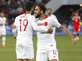 Turkey's Yunus Malli, left, celebrates with team mate Kenan Karaman after scoring his side's opening goal during a friendly soccer match between Russia and Turkey at the VEB Arena stadium in Moscow, Russia, Tuesday, June 5, 2018.