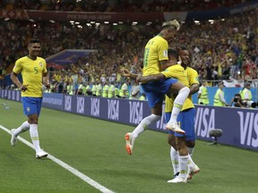 Brazil's Philippe Coutinho celebrates with teammates after scoring his side's opening goal during the group E match between Brazil and Switzerland at the 2018 soccer World Cup in the Rostov Arena in Rostov-on-Don, Russia, Sunday, June 17, 2018.
