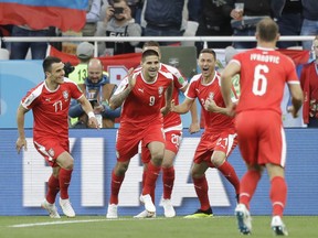 Serbia's Aleksandar Mitrovic, centre, celebrates with teammates after scoring the opening goal during the group E match between Switzerland and Serbia at the 2018 soccer World Cup in the Kaliningrad Stadium in Kaliningrad, Russia, Friday, June 22, 2018.