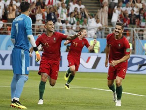 Portugal's Ricardo Quaresma, second left, celebrates scoring his team's opening goal along with teammate Portugal's Andre Silva during the group B match between Iran and Portugal at the 2018 soccer World Cup at the Mordovia Arena in Saransk, Russia, Monday, June 25, 2018.