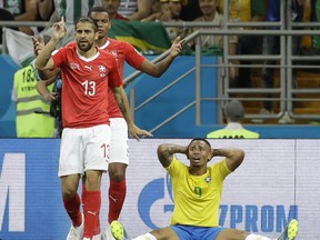 Switzerland's Ricardo Rodriguez, left, and Brazil's Gabriel Jesus, right, react during the group E match between Brazil and Switzerland at the 2018 soccer World Cup in the Rostov Arena in Rostov-on-Don, Russia, Sunday, June 17, 2018.